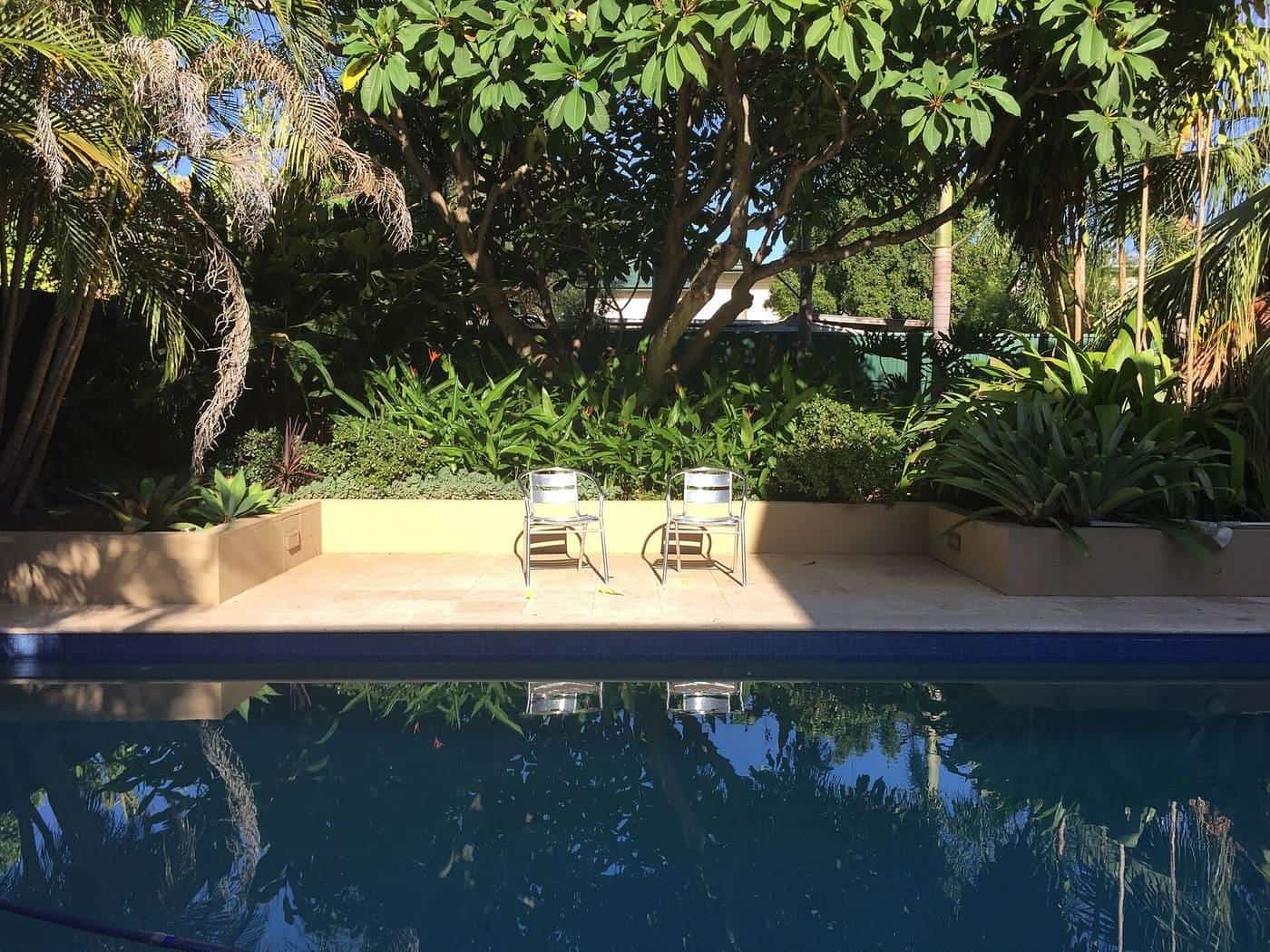 A backyard swimming pool in Queensland on a calm morning