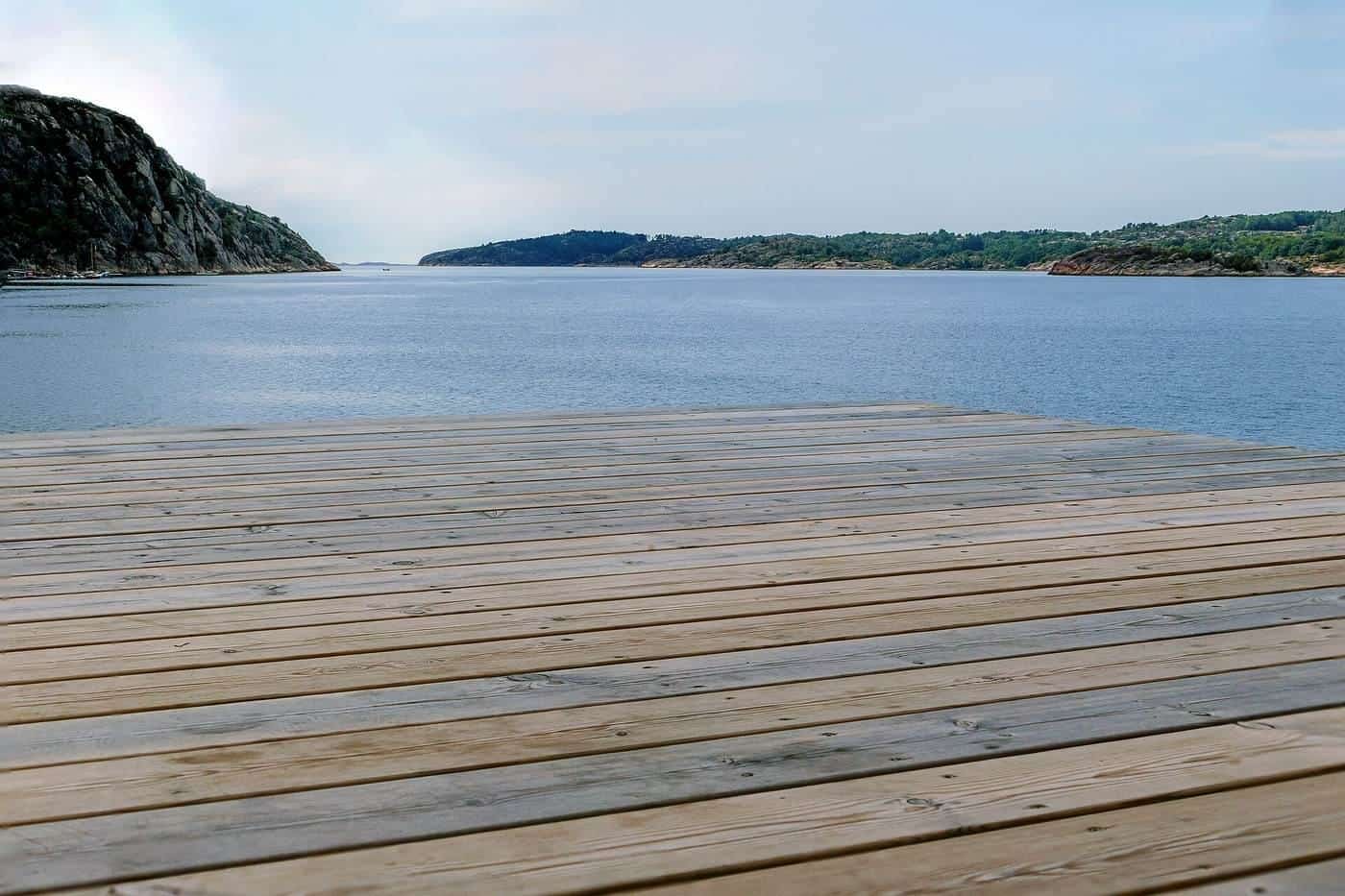 A timber deck overlooking water on a calm day