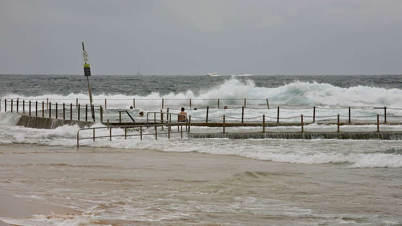 A rock pool and paved surrounds at Mona Vale Beach in Sydney